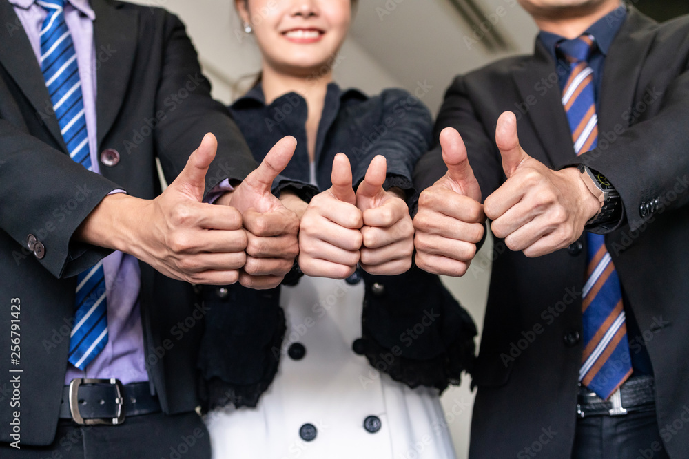 Wall mural Many happy business people make thumbs up sign join hands together with joy and success. Company employee celebrate after successful work project. Corporate partnership and achievement concept.