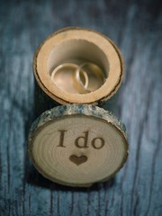 Wedding rings on wooden box Wedding rings in rustic style.