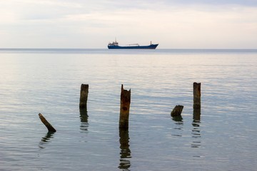 Tranquil seascape with ship at background