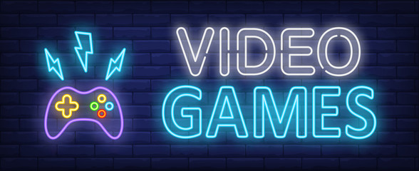 Video games neon text and gamepad with lightnings © RedlineVector