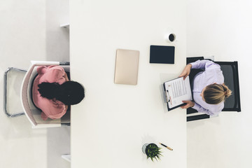 Two young business women in meeting at office table for job application and business agreement....