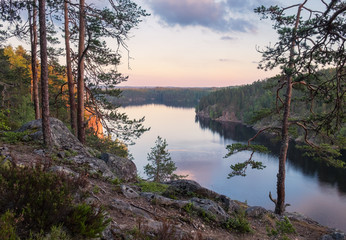 Scenic landscape with woodland and lake view at summer evening in Finland