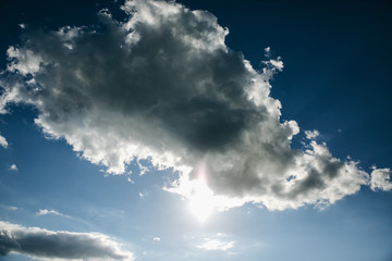 Blue sky with white clouds and green trees.