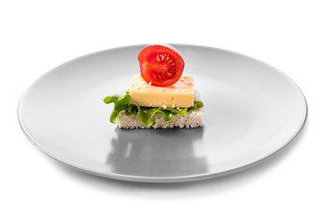 Plate with tasty canape on white background