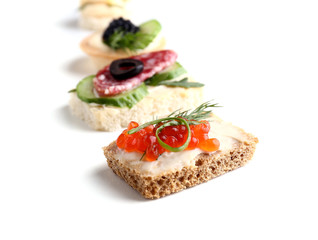 Assortment of tasty canapes on white background