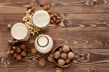 Obraz na płótnie Canvas Assortment of tasty vegan milk on wooden table