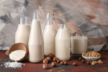 Assortment of tasty vegan milk on table