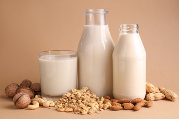 Assortment of tasty vegan milk on color background