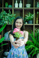 Asian pretty girl has relaxing with happy and smiling at Little Tree Garden cafe, Nakhon Pathom province, Thailand in the morning.