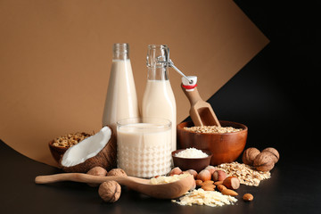 Assortment of tasty vegan milk on dark background