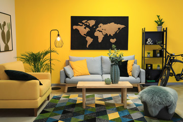 Stylish interior of room with picture of map on wall