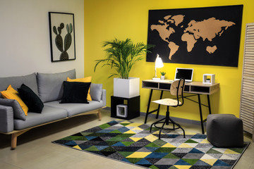 Stylish interior of room with picture of map on wall