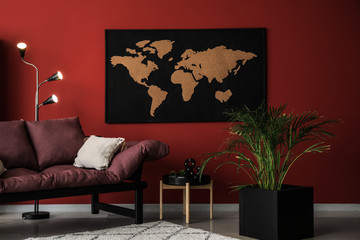 Stylish interior of room with picture of map on wall