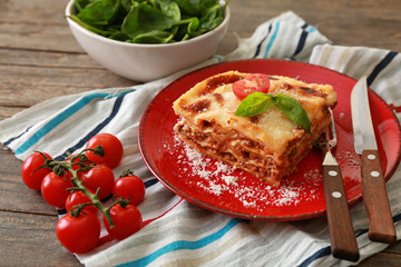 Tasty baked lasagna on wooden table