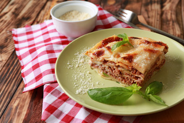 Tasty baked lasagna on wooden table