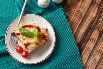 Tasty baked lasagna on wooden table