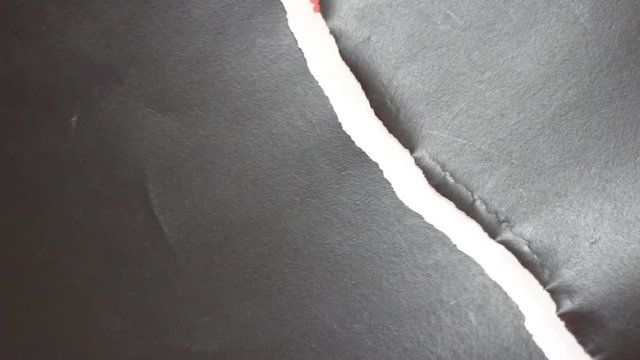 Tearing black paper into red paper screen background