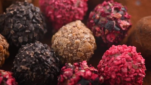 Truffle chocolates. Assorted chocolate praline candies background. Rotation. Slow motion. 4K UHD video footage. 3840X2160