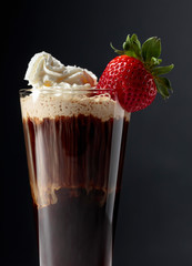 Chocolate drink with whipped cream and strawberry.