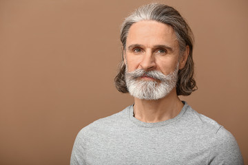 Portrait of mature man on color background