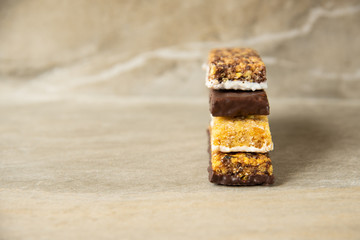 Various muesli bars on marble stone background
