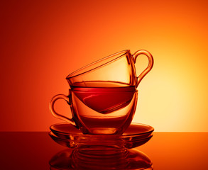 Set of 2 glass cups for tea. Orange Glass Background Set. 