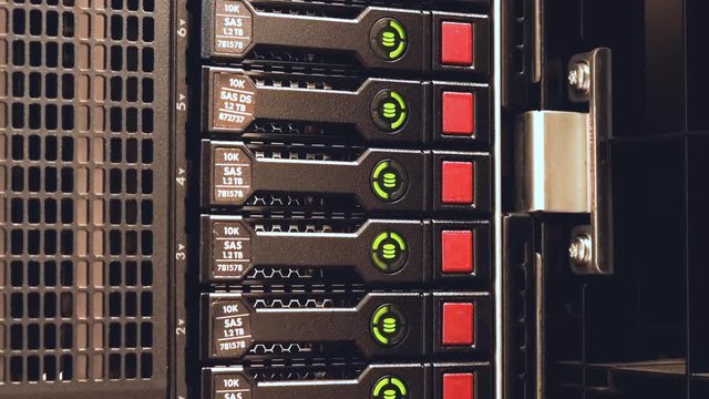 A hard disk array blinks showing read / write activity on a cloud server