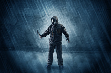 Fototapeta premium Big peril men in front of a crumbly wall with dangerous stuffs in his hand 