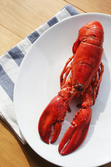 Freshly boiled lobster on a plate on wooden table