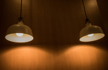 Lighting fixture lamps are hanging on textile classic cable from the ceiling