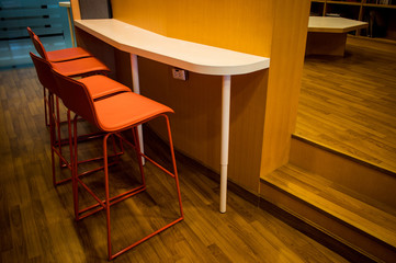 New orange leather seat chairs and wooden counter in the room