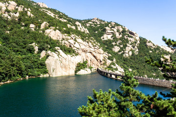 Qingdao, China: a lake in Ba Shui He trail in Mt. Laoshan in Summer. Laoshan mountain features some...