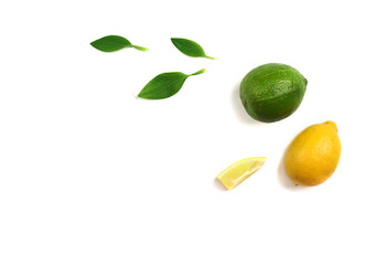 Fruit mix of lemon and lime on a white background with green leaves.