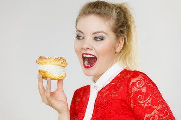 Funny woman holds cream puff cake