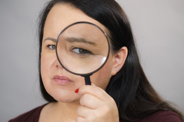 Adult woman with magnifying glass