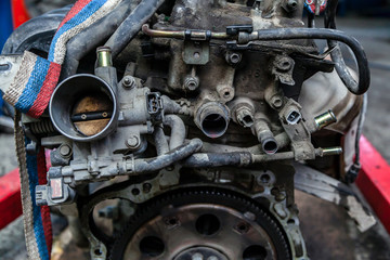 Close-up of the engine, throttle, raditor. Engine breakdown: contaminated throttle of an old car