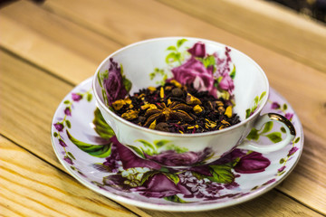 Obraz na płótnie Canvas cup of herbal tea with spices on a light wooden background