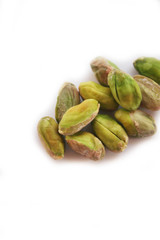 Shelled pistachios isolated on white background in selective focus
