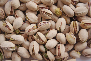 Fototapeta premium Pistachios background in selective focus. Nuts background