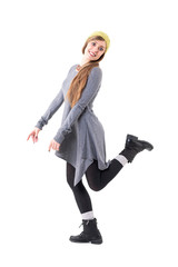 Fototapeta premium Side view of stylish authentic happy young cute girl posing with leg raised up. Full body isolated on white background. 
