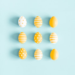 Easter composition. Easter eggs on pastel blue background. Flat lay, top view, square