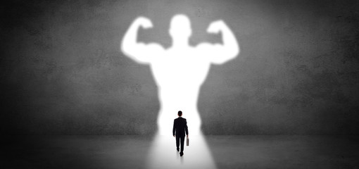 Businessman standing and dreaming about a strong superhero