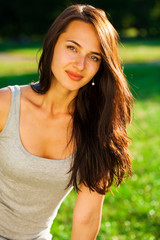 Young brunette woman in summer park