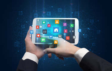 Hand using tablet with colorful bounce application symbols and icons concept
