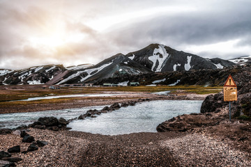 Beautiful Landmanalaugar gravel dust road way on highland of Iceland, Europe. Muddy tough terrain for extreme 4WD 4x4 vehicle. Landmanalaugar landscape is famous for nature trekking and hiking.