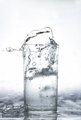 Naklejka na ściany i meble water splash in glass isolated on white