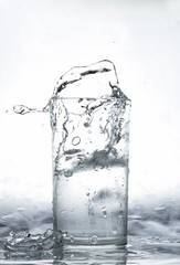 water splash in glass isolated on white