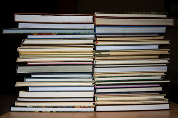 stack of books in a multi-colored cover, close-up