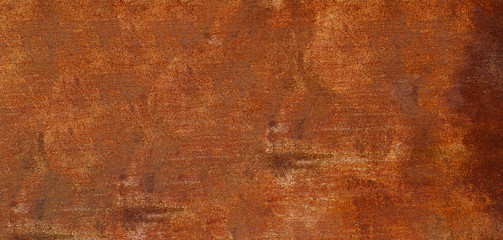 Panoramic rusty yellow-red textured metal surface. The texture of the metal sheet is prone to oxidation and corrosion. Textured background in grunge Style