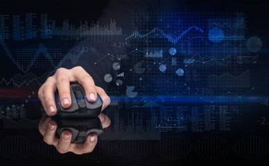 Hand using wireless mouse with financial concept on dark background

